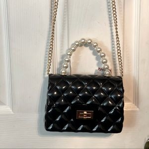 I am selling a small patent leather purse with a pearl hand strap so gorgeous!